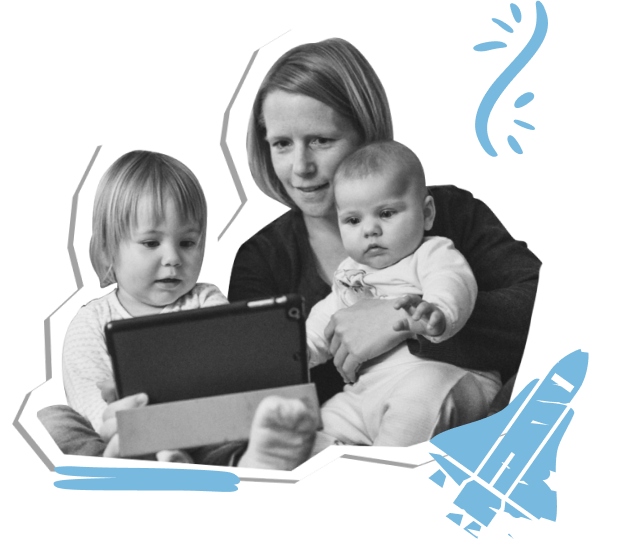 A person holding a baby and sitting with a toddler. All three are looking at a tablet and exploring the content.